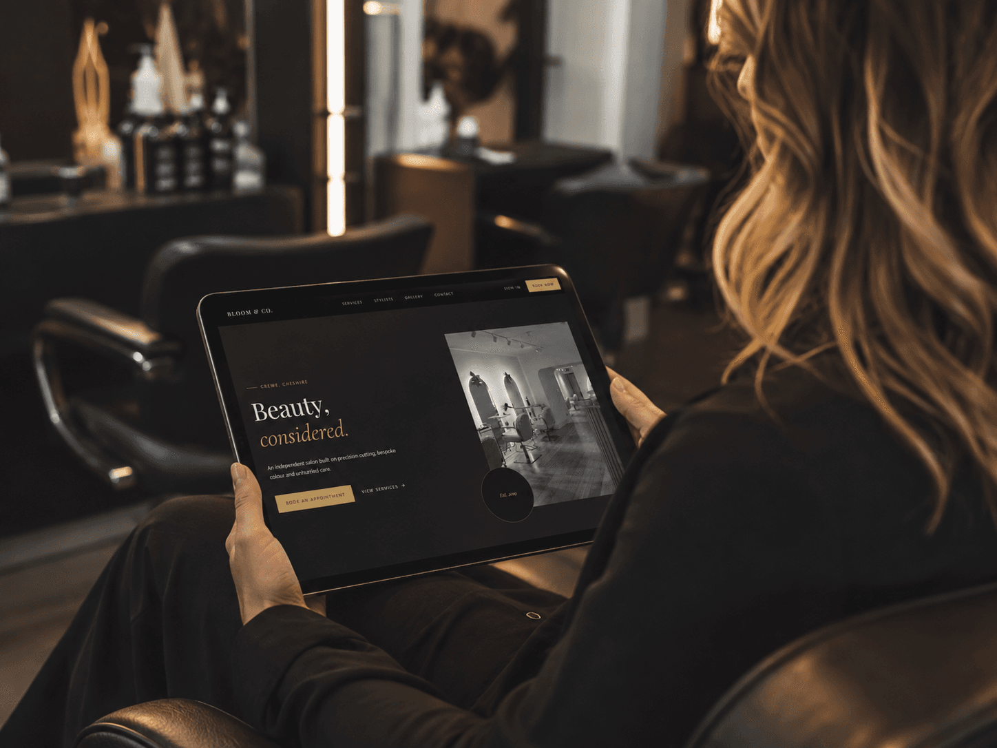 A salon owner viewing her live SalonDo booking site on a tablet